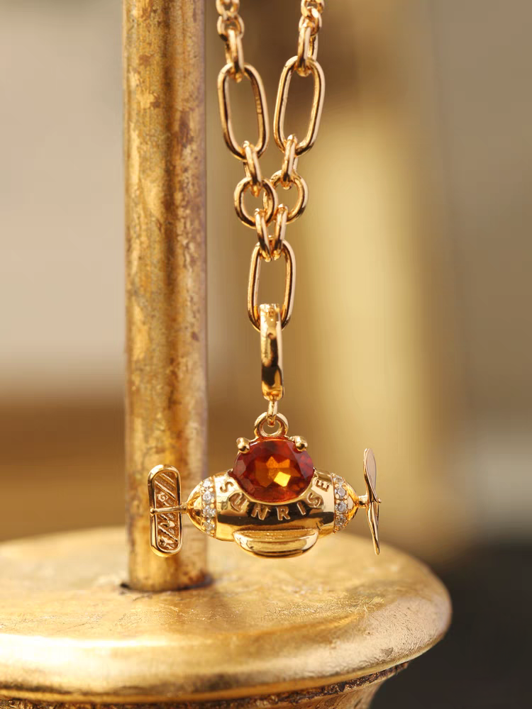 The Perfect Gift for Dreamers: The Sunrise Spessartite Garnet Airplane Necklace