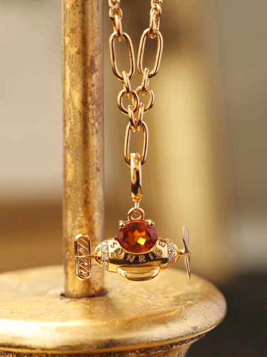 The Perfect Gift for Dreamers: The Sunrise Spessartite Garnet Airplane Necklace