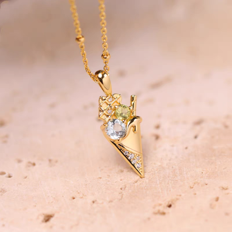 Collar de helado de la colección Sobremesa, diseño original artesanal de Kemstone. Colgante de plata 925 bañada en oro con topacio azul y peridoto. Un regalo de lujo para mujer.